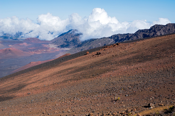 rock strewn slope and mountain peak above haleakala crater floor