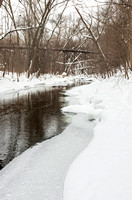 Minnehaha Creek Flowing Under Bridge in Winter