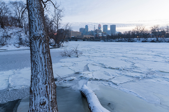 minneapolis skyline and frozen mississippi river at dusk