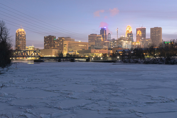 minneapolis skyline and frozen mississippi river at twilight