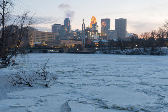 frozen mississippi river and minneapolis skyline